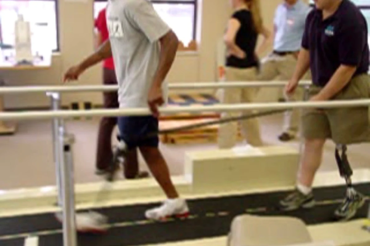 Amputee walking with support in parallel bars